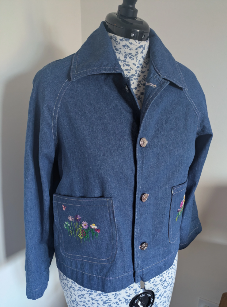 Swing denim jacket with embroidered pockets.